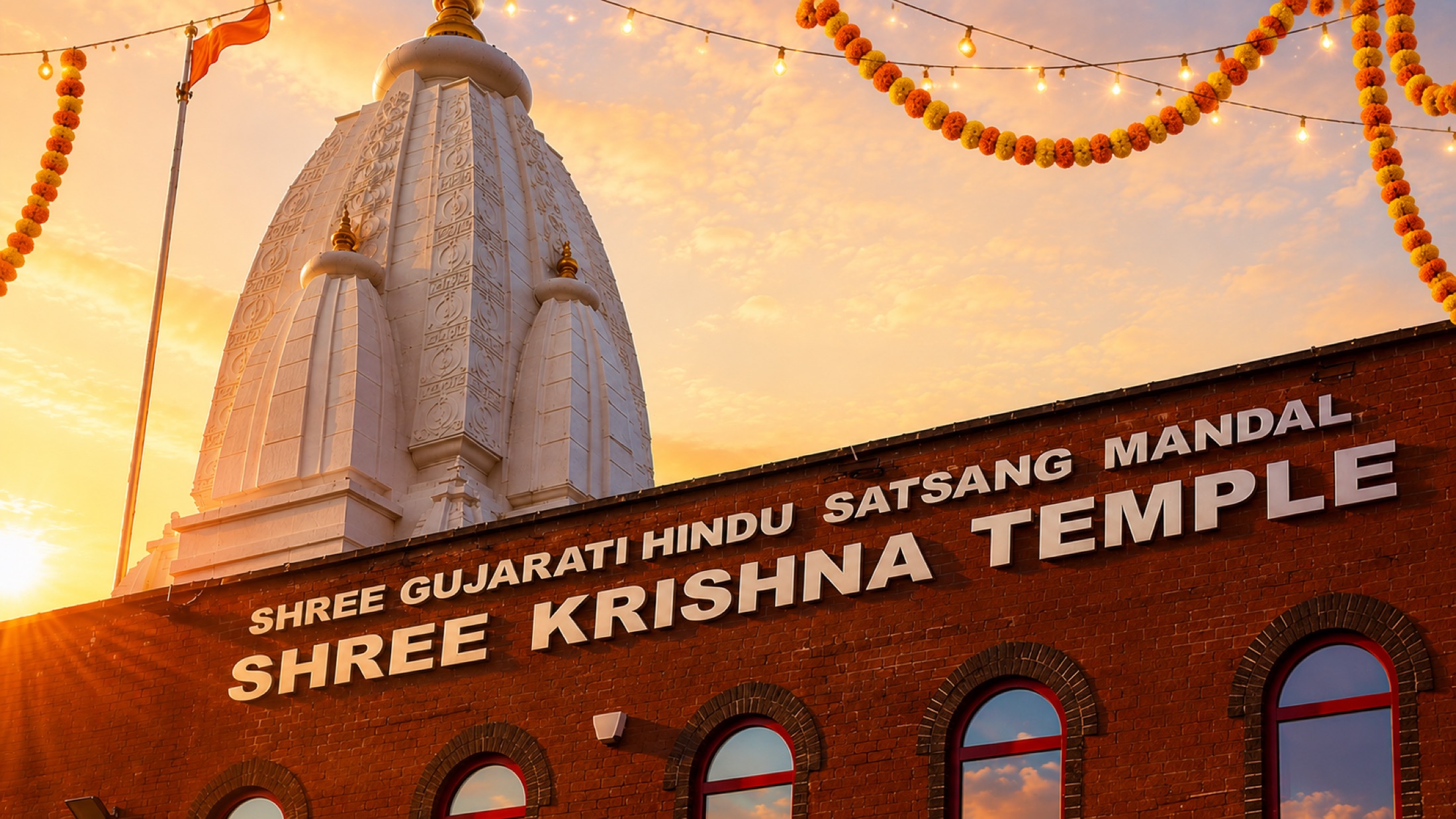 The white shikhar of Shree Krishna Temple at sunset, with marigold garlands above the temple hall